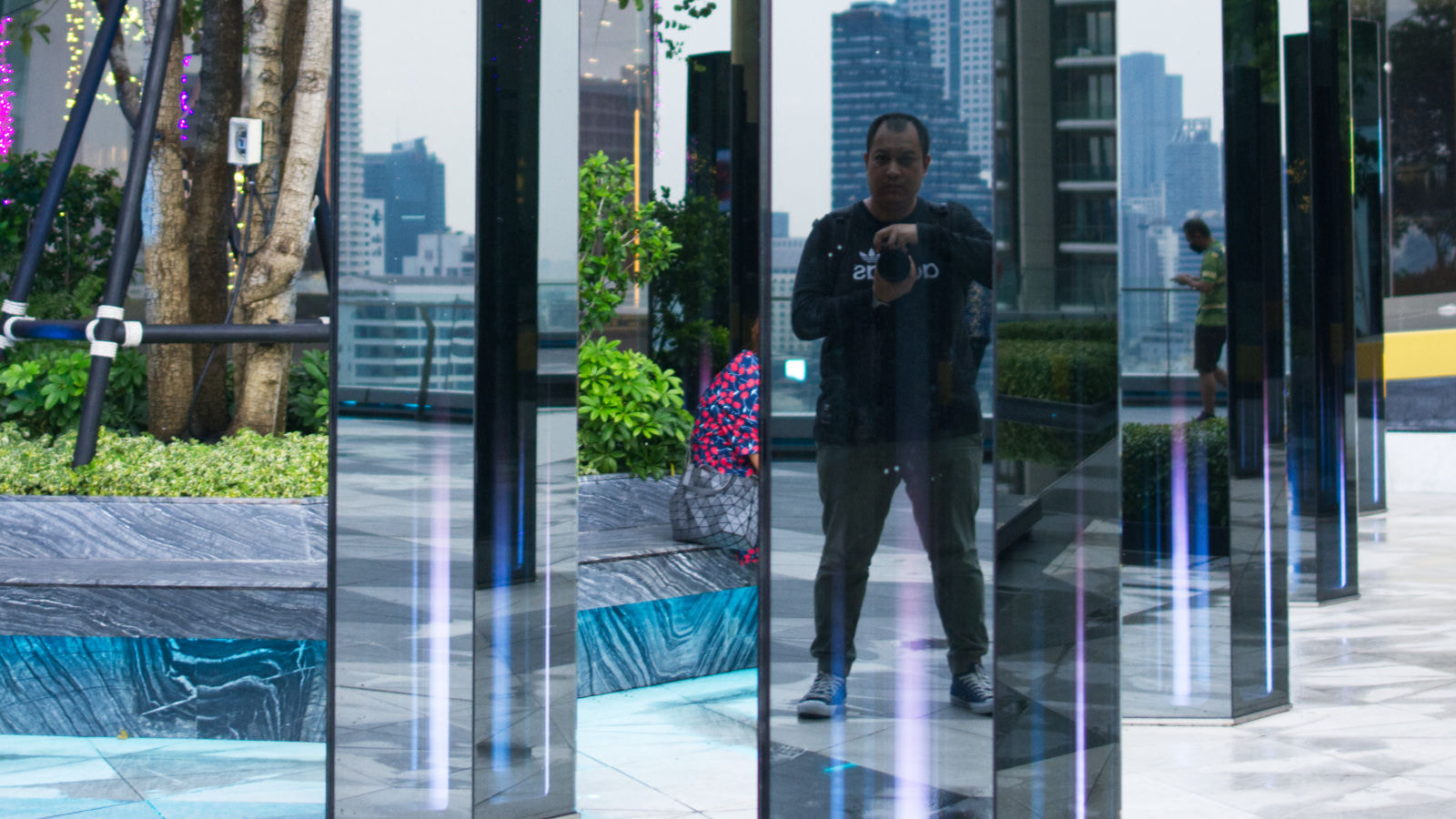 The photo of Khaled Nobani is taking a photo of himself reflected on the big bar of crystal clear mirror in iconsiam
