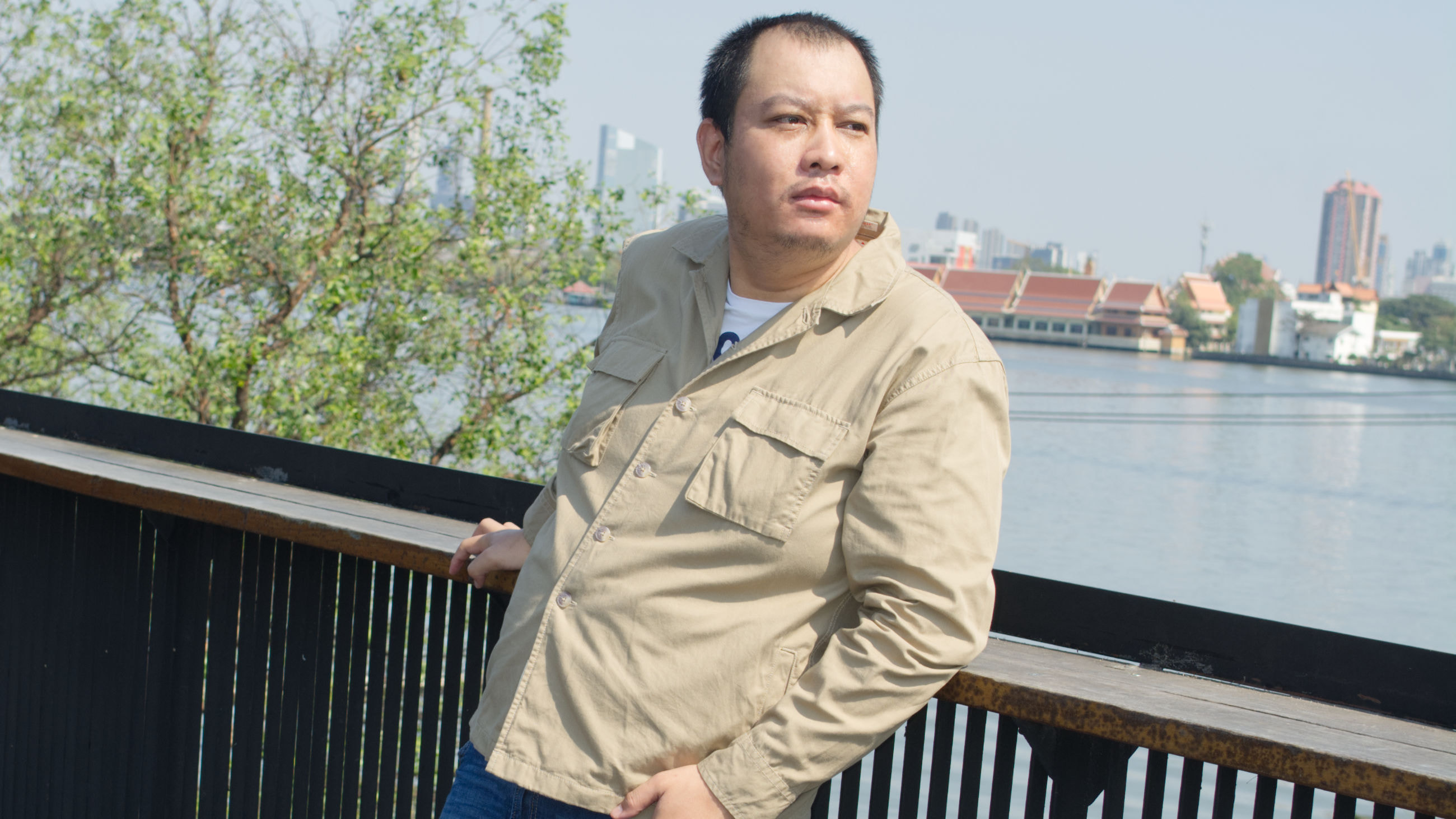 A man standing in top roof of cafe beside the Chao Phraya river located in Bangkok, Thailand